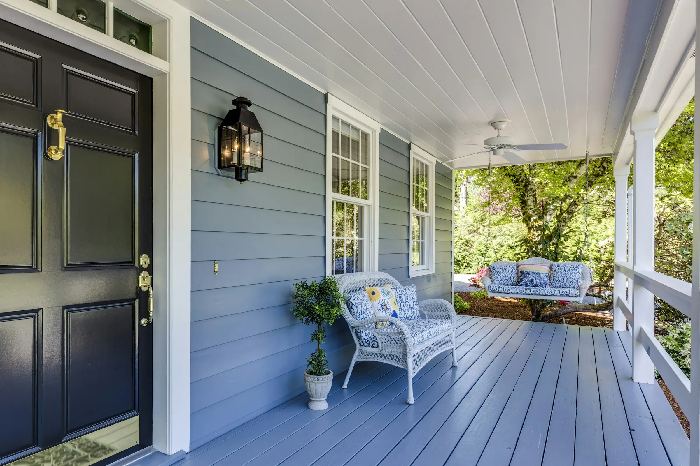 Welcoming front door and porch of a residential home on a spring day