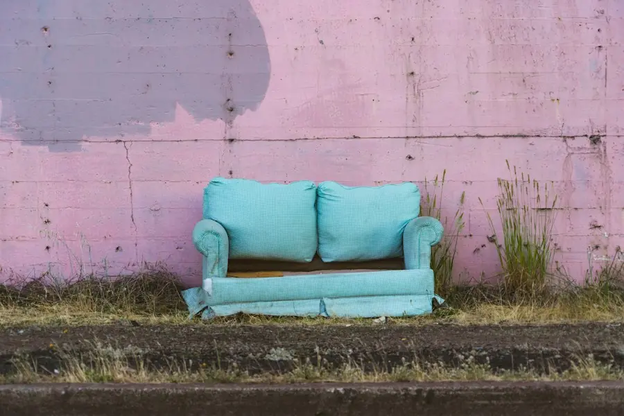 Old couch left against a wall, ready to be hauled away