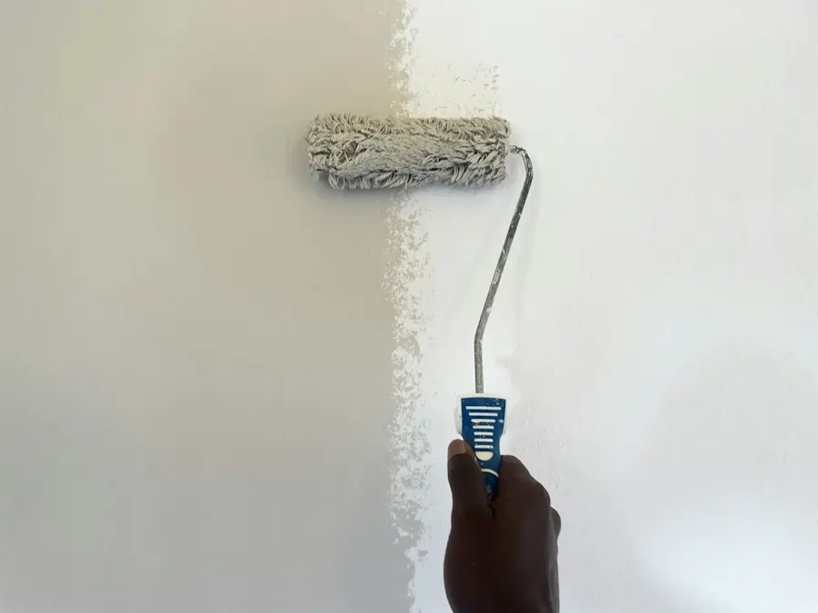 Paint roller applying a fresh coat of paint to an interior wall