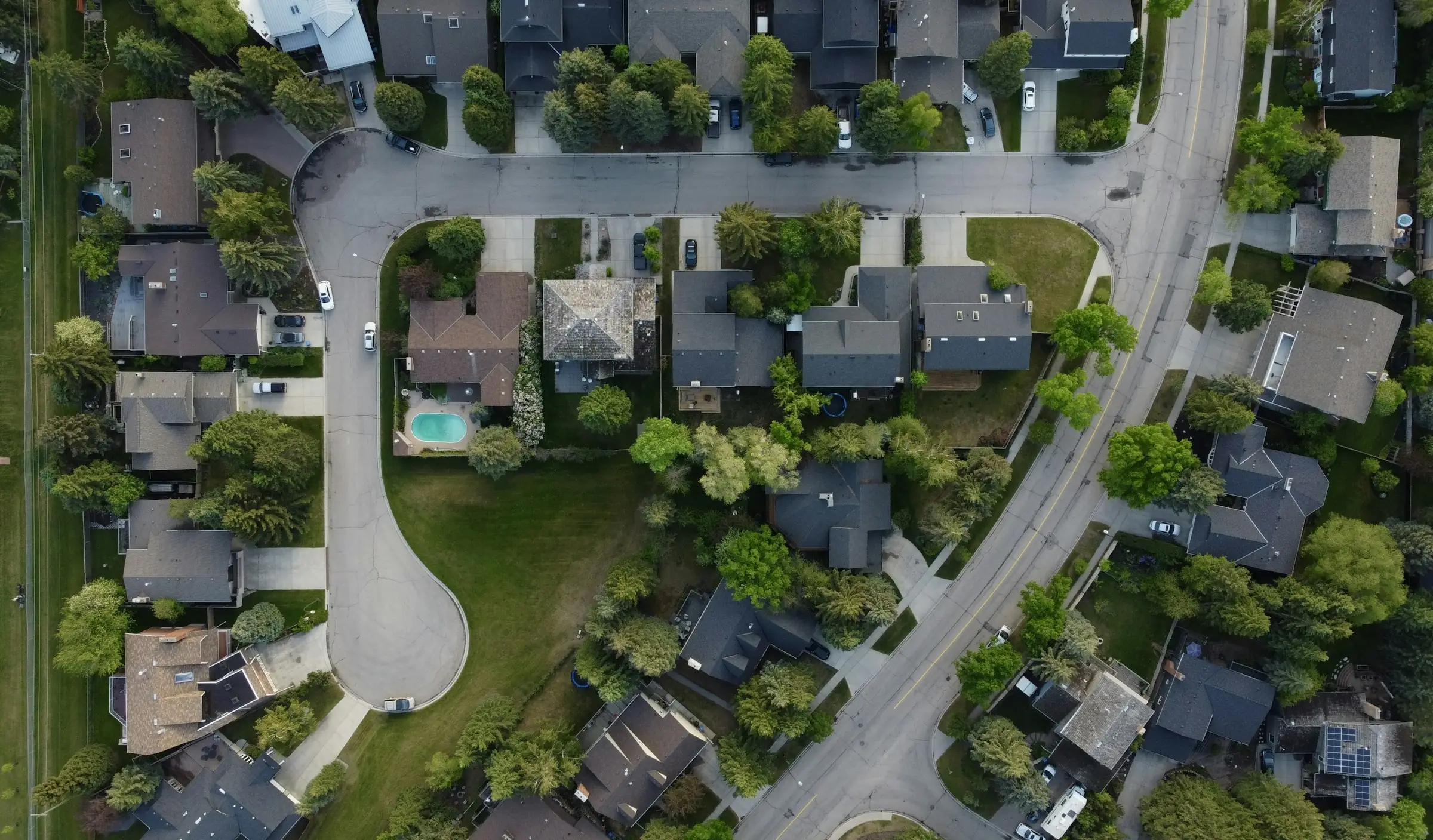 Aerial view of residential properties with green lawns in an Iowa neighborhood