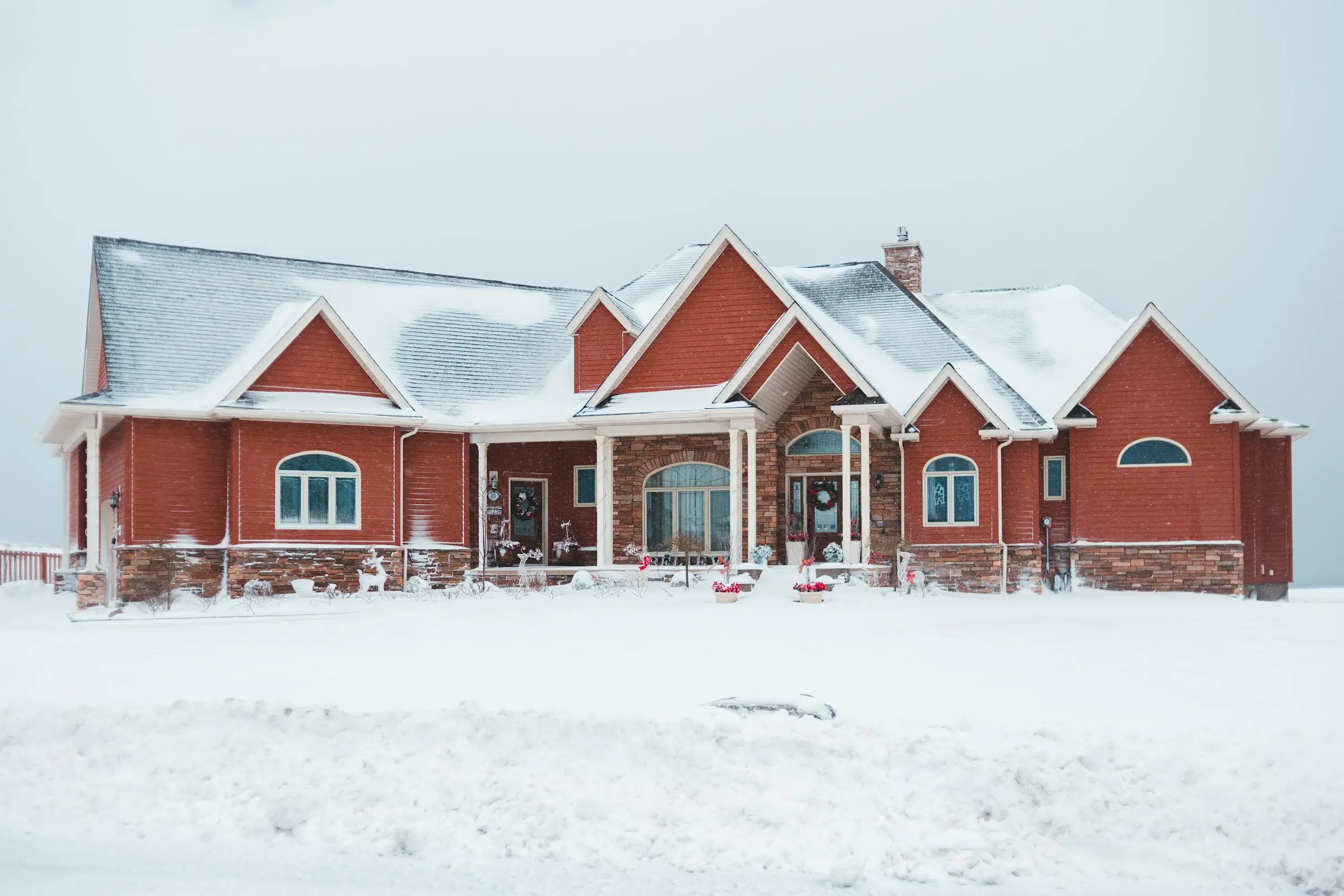 Brick ranch home and front yard after a fresh winter snowfall in Iowa